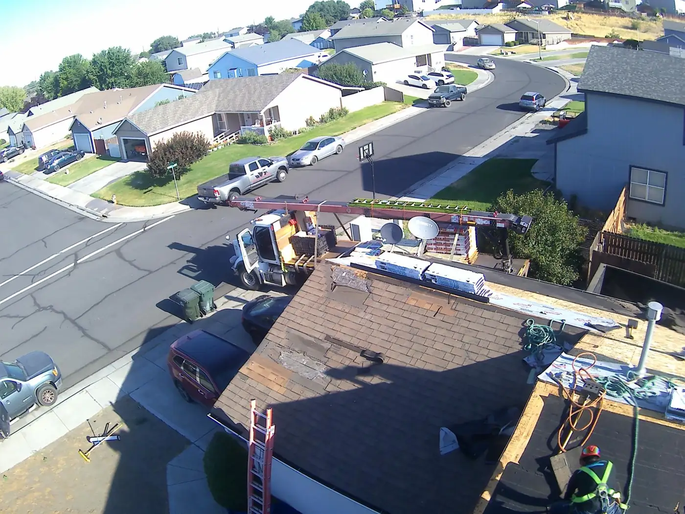 Crew tearing off an old roof in a residential neighborhood