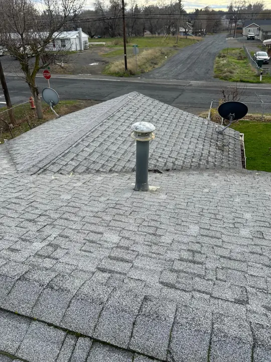 Aging gray shingle roof during inspection