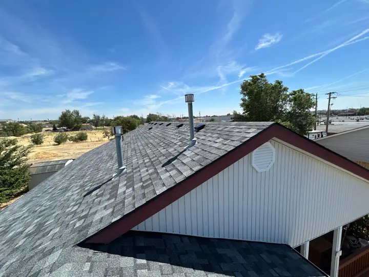New gray shingle roof with gable trim